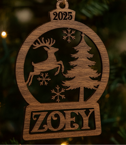 Wooden ornament with reindeer, tree, and snowflakes design, featuring the year 2025 and name 'Zoey', hanging on a Christmas tree.