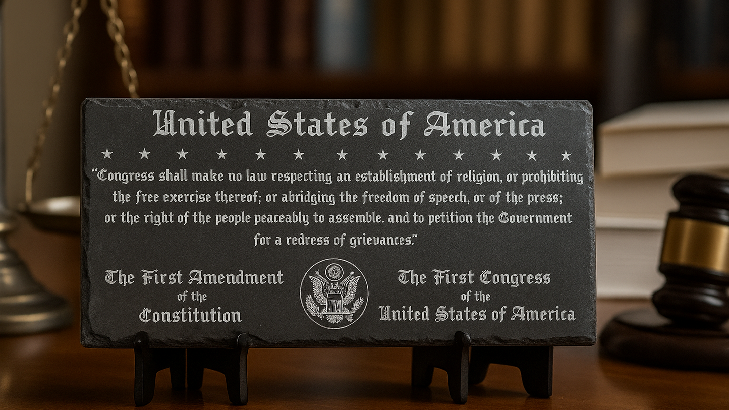 Slate plaque with the First Amendment text of the United States Constitution on a wooden stand.