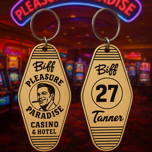 Two keychains with 'Pleasure Paradise Casino & Hotel' branding in a casino setting.
